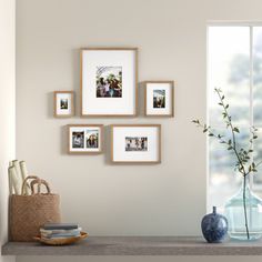 a shelf with pictures and vases on top of it next to a window sill