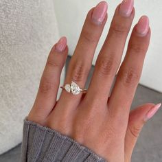 a woman's hand with a diamond ring on it