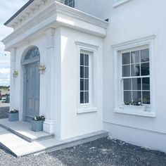 a white house with blue door and windows