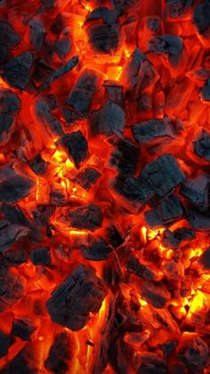 hot coals are lit up and glowing in the dark