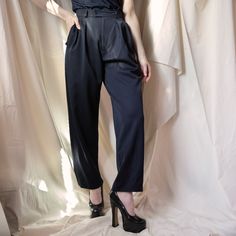 From YSL’s Rive Gauche line, these trousers are the perfect staple to add to your closet. The double button waistband and double pleats in the front allow for a comfortable yet incredibly flattering fit and the loose, almost wide leg cut of the trousers allow for easy styling with sneakers and heels alike. Beautiful and well-made, these are a great example of why people shop vintage. Size: FR 36, US 2/4 Composition: 100% wool Condition: Perfect, no visible stains, snags, holesMeasurements: Waist High-waist Bottoms With Pressed Crease For Spring, High Waist Bottoms With Pressed Crease For Spring, High Waist Pantsuit With Belt Loops For Office, Evening Pants With Belt Loops For Spring, Fall High Waist Pleated Bottoms, Tailored Pleated Workwear Bottoms, Workwear Bottoms With Pleated Waist Trousers, Tailored High Waist Pantsuit With Belt Loops, Workwear Trousers With Pleated Waist