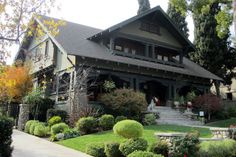 a large house with lots of plants in front of it