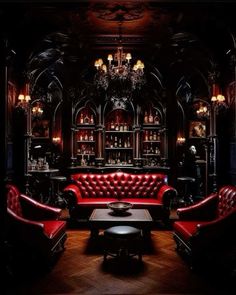 a living room filled with red couches next to a table and chandelier