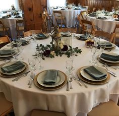 the table is set with silverware and place settings