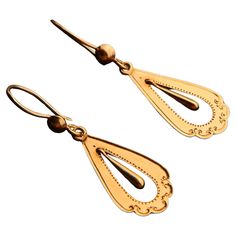 A pair of drop shaped Antique Swedish dangles in solid 18K Gold . A pair of European ca. 1920s -1930s earrings with drop shaped pendants and delicate hand- engraved ornaments. Freely suspended inner drop dangles are hollow inside. Hooks hallmarked 18K , all parts tested solid 18K Gold. Each earring is 40mm long suspended x 12 mm at widest. Weight: 2.1 grams pair. Condition is finest used, no repairs , all parts original. > Most of the items that we sell are not new at all if not stated otherwise 1930s Earrings, Ornate Dual-tone Gold Earrings, Vintage Charm Brass Drop Earrings, Vintage Brass Drop Clip-on Earrings, Art Nouveau Gold Collectible Jewelry, Vintage Yellow Gold Dangling Charms, Engraved Ornaments, Old Rings, Photo Equipment