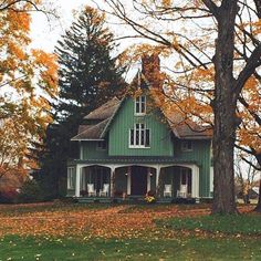 a green house surrounded by trees and leaves