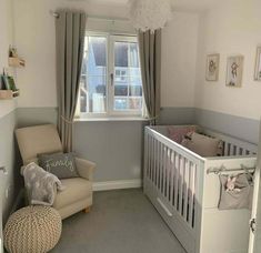 a baby's room with a crib, chair and window