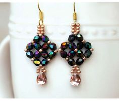 a pair of earrings with black and pink beads