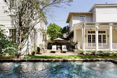 a pool in front of a white house