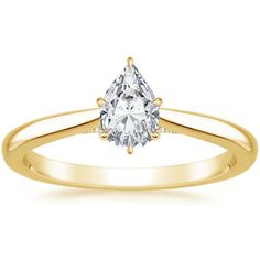 a yellow gold engagement ring with three pear shaped diamonds