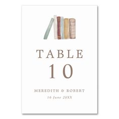 a table number with books on it and the words'table 10'written in brown ink