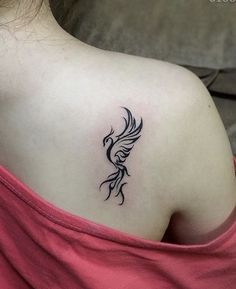 a woman with a tattoo on her back shoulder