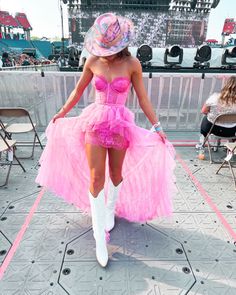 a woman in a pink dress and cowboy hat