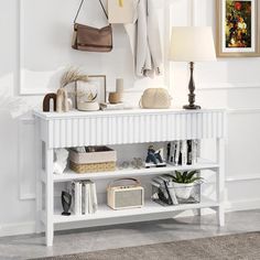 a white shelf with purses, books and other items on it in a room