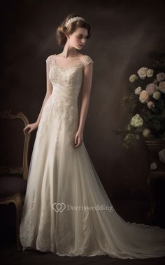 a woman in a wedding dress standing next to a chair