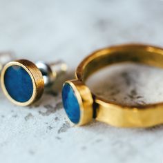 These beautiful Lapis Lazuli rings are the perfect addition to any jewelry collection. The set includes both the earrings and the ring ♥ 4mm Pewter Band - Plated With 24k Gold ♥ Bezel 8 x 8 x 2mm ♥ Ring bezels are inlay-ed with Lapis Lazuli 100% Natural ♥ The Two Components Are *Joined* Using Epoxy Lapis Lazuli is one of the most sought after stones in use since man's history began. Its deep, celestial blue remains the symbol of royalty and honor, gods and power, spirit and vision. It thought to Brass Jewelry With Bezel Setting For Gift, Blue Brass Ring Jewelry, Round Brass Jewelry With Bezel Setting, Blue Brass Jewelry For Wedding, Blue Brass Round Jewelry, Blue Round Brass Jewelry, Round Brass Birthstone Jewelry, Blue Brass Jewelry For Anniversary, Gemstone Ring Earrings As Gift