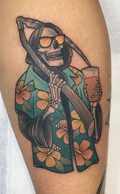 a person with a tattoo on their leg holding a drink and a sculler