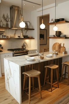 a kitchen with two stools next to an island in the middle of the room