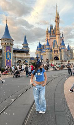 a woman standing in front of a castle