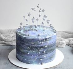 a blue cake with silver stars on top