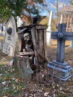 a cemetery with tombstones, graves and a skeleton sitting in the middle of it