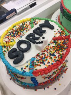 there is a birthday cake with the name oscar on it and sprinkles