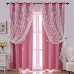 the curtains are pink and white with sparkles on them, along with a chair