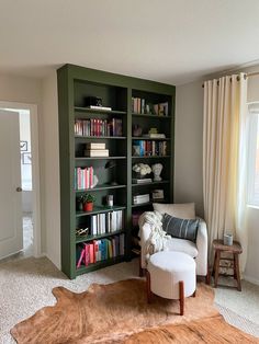 a living room filled with furniture and bookshelves