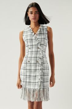 Sassy and classy. This plaid tweed sleeveless dress features double breasted buttons, fringe trim along the neckline and trails to the hem. Princess seams create shape to the garment and side pocket details are added at both sides. Pair the look with black pointed heels for further elevated look.- Tweed- Fringe detail- Exposed embellished buttons- Mini dress- Color: Ivory MultiSize + Fit - Model is 5'9" and wearing size XS- Measurements taken from size S - Chest: 34"- Length: 32 1/2" FabricSelf: Black Pointed Heels, Embellished Buttons, Crystal Buttons, Pointed Heels, Fringe Dress, Princess Seams, Tweed Dress, Plaid Fabric, Button Dress