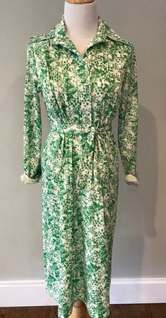 Super cute vintage floral shirtdress -green and white. Covered bottoms.  Size med/ large-  chest measurement is 17 across.  Good condition- fully lined . Green Long Sleeve Shirt Dress For Daywear, Green Shirt Dress For Summer Dress Down, Green Shirt Dress For Summer, Green Cotton Shirt Dress For Daywear, Green Floral Print Dress For Daywear, Green Cotton Shirt Dress For Spring, Spring Floral Print Shirt Dress, Green Long Sleeve Floral Print Shirt Dress, Green Button-up Shirt Dress For Day Out