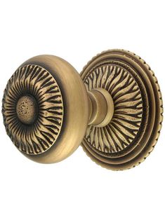 an antique brass door knob with decorative design