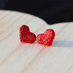 These stunning red glitter heart stud earrings are even prettier in person!  They're lightweight and hypoallergenic stainless steel for sensitive ears.  These heart love stud earrings are perfect for Valentine's Day and everyday wear.   They're handmade with polymer clay.  These sweet earrings look amazing with jeans and your favorite top as well as dresses and skirts.  You can dress them up or down. Earring Details ❤️ Hypoallergenic stainless steel posts for sensitive ears ❤️ Measure approximately 12mm in diameter ❤️ Soft clear silicone earrings backings for comfort ❤️ Packaged on a high quality earring card and in a gift box with satin ribbon ❤️ Handmade with polymer clay  Shop our entire collection of Valentine's Day earrings here... https://www.etsy.com/shop/LakeandLark?ref=seller-plat Red Glitter Earrings For Gift, Glitter Red Earrings For Gifts, Heart-shaped Glitter Earrings For Gifts, Heart Shaped Glitter Earrings For Gift, Glitter Heart Earrings As Gift, Red Hypoallergenic Heart Earrings For Valentine's Day, Stud Earrings Polymer Clay, Valentines Day Earrings, Ribbon Handmade