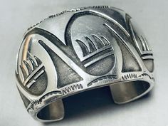 #1 Best Quality Free Returns! Vintage and Museum Quality Specialists Best Customer Service Free Shipping! Vintage and Museum Quality Click side of pic to view next picture (Click side of pic to view next picture) This is a magnificent vintage Navajo hand carved silver cuff bracelet. This fascinating bracelet consists of deep carvings that include geometric patterns and paw patterns. The detailing of the carvings on the bracelet is just astonishing. Bordering the edges of the very thick and sturdy wide silver cuff are outstanding silver wave works and sun stampings. The width of the bracelet measures around 1-1/2". Sterling silver. Cir. Mid century. The inside end to end measures around 5-1/4" with an additional 1-1/4" gap. Sturdy 97 grams. -FREE            Lifetime Warranty -FREE Medicine Pouch, Paw Pattern, Vintage Navajo, Silver Cuff Bracelet, Sterling Silver Bracelet, Silver Cuff, Bracelets And Charms, Geometric Patterns, Sterling Silver Bracelets