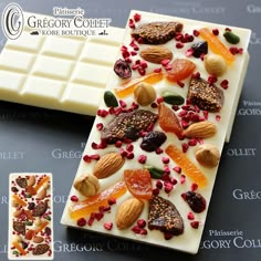 a piece of white chocolate with fruit and nuts on it