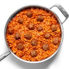 a pot filled with pasta and meatballs