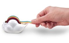 a person is holding a toothbrush with a rainbow in it's mouth on a white background