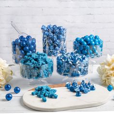 blue and white candies are arranged on a platter next to other candy items