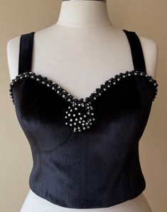 This velvet corset, which we named Noble Lady, was handcrafted individually in our workshops. Each model is worked on only one size and is personalized. The beads and materials on it were carefully selected and hand-sewn. Your cargo is carefully packed and sent to you. Size: EU 42  Adjustable corset with back tie Dimensions are flexible 6 cm (2,5 in) Color: Black Luxury Underbust Bodice For Party, Vintage Evening Corset With Fitted Bodice, Vintage Fitted Bodice Corset For Evening, Embellished Corset With Fitted Bodice For Evening, Embellished Evening Corset With Fitted Bodice, Vintage Sleeveless Evening Corset, Vintage Sleeveless Bodice For Wedding, Vintage Sleeveless Wedding Bodice, Elegant Corset With Fitted Bodice For Vintage Events