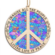 a wooden ornament with the words imagine all the people living life in peace