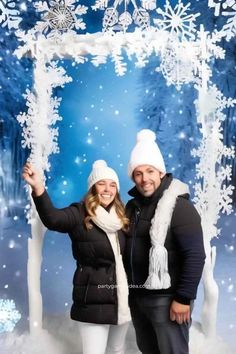 two people are posing for a photo in front of snowflakes