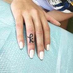 a woman's hand with a small tattoo on it