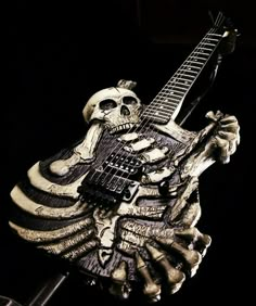 a statue of a skeleton holding a guitar