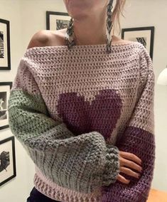 a woman wearing a sweater with hearts on it