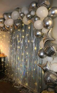 a room filled with balloons and disco balls