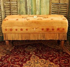 an old bench with fringe and stars on it