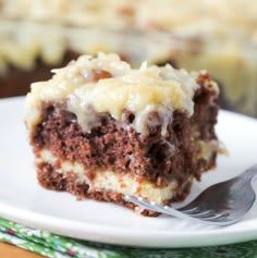 a piece of cake sitting on top of a white plate with a fork in it