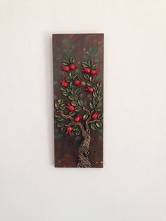 a painting on a wall with a tree and red flowers in the center, against a white background