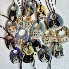 a bunch of cats that are hanging on some strings with tags attached to the back of them