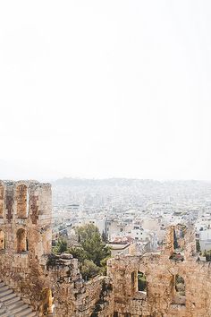 an old building in the middle of a city with lots of stone walls and windows