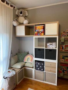 a child's playroom with toys and bookshelves in the corner, including a teddy bear